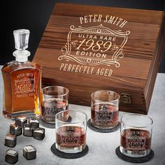 an assortment of whiskeys and glasses in front of a wooden box that says, peter smith ultra rare limited edition perfectly aged