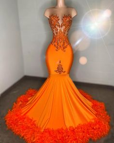 Show-stopping mermaid gown in a vibrant orange hue Intricate beadwork and embellishments adorn the sheer bodice for a dazzling effect Form-fitting silhouette that flares into a dramatic train Feather accents along the hemline add a touch of whimsy and elegance Ideal for prom, galas, and other glamorous events Made with premium fabrics to ensure comfort and durability Available in various sizes for a perfect fit Orange Prom Dresses For Sale, Plus Size Orange Prom Dresses, Orange Masquerade Dress, Orange Sweet 16 Dresses, Neon Orange Dress Prom, Orange And Silver Prom Dress, Orange And Gold Prom Dress, Orange Dresses Prom, Orange Prom Dresses Long