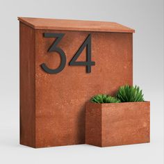 a planter that is sitting next to the number 544 on a concrete block