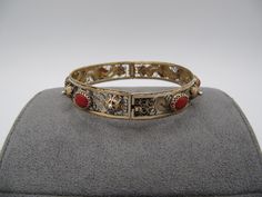 "Vintage 800 Silver Vermeil Coral Filigree Hinged Bangle Bracelet. It will fit a wrist up to 7 inches(18 cm) and it measures 12 mm wide. The coral cabochons are 8.5 mm by 7 mm. The piece is marked on the clasp \"800\" and the total weight is 18.1 grams. The bracelet is in good condition with some wear showing." Ornate Hinged Bangle Bracelets, Ornate Hinged Bangle Bracelet, Ornate Hinged Bracelets For Gifts, The Bangles, The Coral, Hinged Bangle, Bangle Bracelet, Bangle Bracelets, Jewelry Bracelets