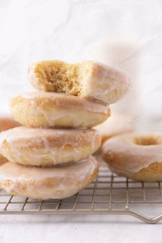 a stack of doughnuts sitting on top of a cooling rack