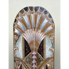 an art deco mirror is shown against a wall