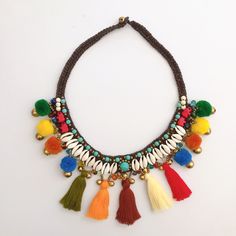 a multicolored necklace with tassels and beads