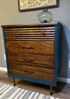 Check out this stunning MCM four drawer dresser that has been completely refurbished, complete with its original hardware. Each drawer is lined with premium shelf liner in coordinating colors. The drawer fronts and top have been beautifully stained in a rich dark honey, while the dresser itself is a striking midnight blue. It's a one-of-a-kind piece that's sure to make a statement in any room! **Please contact us before checking out for shipping quote. Shipping costs will vary depending on your Restained Dresser Wood Furniture, Ipcycle Dresser, Two Tone Dresser Painted, Four Drawer Dresser, Two Tone Dresser, Dresser Painted, Shelf Liner, Furniture Redo, Bedroom Furniture Dresser