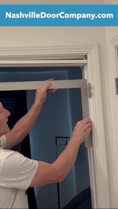 a man is opening the door to his house with an ad for nashville door company