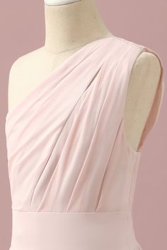 the back of a dress on a mannequin headdress in front of a pink background