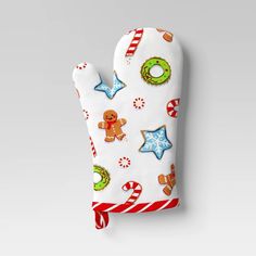 an oven mitt decorated with gingerbreads, pretzels and christmas cookies