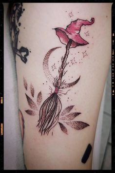 a woman's thigh with a flower tattoo on it