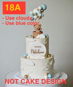 there is a white cake with blue and gold decorations on the top, and an image of a teddy bear above it