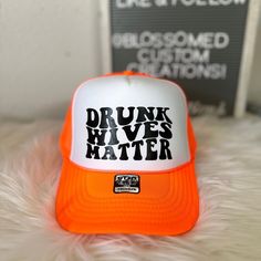 Drunk Wives Matter available in 17 different color hats to choose from.  Classic Plain & 2 Tones BK Caps Trucker Hats (With a slightly curved bill, not flat, not too curve)  5 Panel SnapBack Mesh Trucker Caps Hats 100% Polyester Front 100% Polyester Mesh Back The Traditional Look: 5-panel cap Seamless Foam Front Panel with Lining Matching Color Braid 8 Rows Stitching on Visor Matching Fabric Undervisor Matching Color Sweatband Plastic Adjustable Snap ❤ Production and Shipping: ❤  All Hats are se Adjustable Hats With Letter Print, Adjustable Wide Brim Hat With Letter Print, Orange One Size Fits Most Cap, Orange Short Brim Hat, One Size Fits Most, Orange Cap, One Size Fits Most, Orange Hat With Short Brim, One Size Fits Most, Adjustable Orange Hat With Letter Print, Orange Letter Print Cap, Orange Snapback Hat For Beach