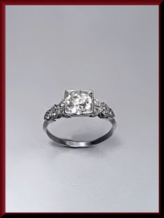 a white gold ring with an old cut diamond