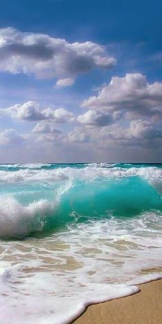 the ocean waves are crashing on the beach