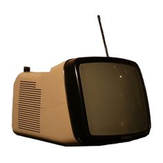 an old fashioned television sitting on top of a white surface with the screen turned off