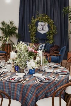 the table is set with plates and place settings