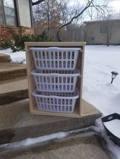 three white baskets sitting on top of snow covered steps