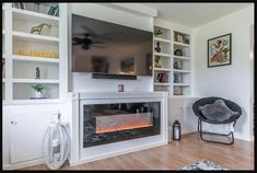 a living room with a fire place and bookshelves