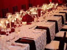 a long table is set with candles and flowers for a formal dinner or wedding reception