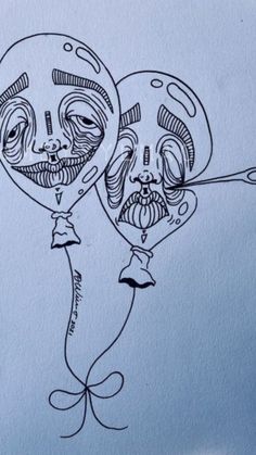 a drawing of two balloons with faces on them