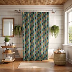 an image of a bathroom setting with shower curtain and rugs on the floor in front of the bathtub