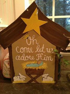 a nativity scene made out of cardboard with a star on top and the words, oh come let us adore him