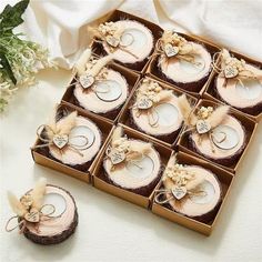 a box filled with lots of different types of wedding rings next to some white flowers