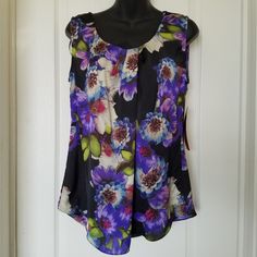 Beautiful Flowy Floral Fabric. Nwt. One Tiny Flaw On The Shoulder: Fabric Is Scuffed On The Edge. See Last Pic. Great For Spring. Career Or Casual. 19" Pit To Pit. 25" Shoulder To Hem In Front And 28" Shoulder To Hem In Back. Elegant Purple Tank Top, Multicolor Floral Print Tank Blouse, Purple Sleeveless Blouse For Spring, Purple Sleeveless Blouse Tank Top For Summer, Purple Sleeveless Tops, Casual Purple Tank Top With Floral Print, Elegant Multicolor Sleeveless Blouse, Purple Floral Print Summer Tank Top, Summer Purple Floral Print Tank Top