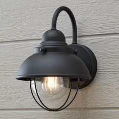 an outdoor light on the side of a house