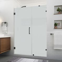 a bathroom with a sink, toilet and shower stall in the middle of the room