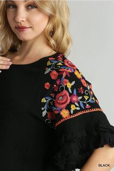 Step up your fashion game with our Floral Embroidered Round Neck Top! Crafted from a luxurious blend of 55% linen and 45% cotton, this top offers both comfort and style. The full front and back of this gorgeous top is a lovely solid go with anything black which provides a chic backdrop for the vibrant, multi-colored embroidery on the sleeves. The unfinished frayed hem adds a trendy, casual touch. Perfect for any occasion, this top is sure to become a staple in your wardrobe. Models are wearing s Round Neck Top, Slipper Socks, Round Neck Tops, Hat Hairstyles, Step Up, Fashion Games, Multi Colored, Small Gifts, Sleeve Top