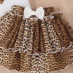 Such a purrrfect outfit! Pair with a denim jacket or our Trinity Moto Jacket for a chic Fall look. White or Black sleeveless shirt with leopard print applique. Matching layered leopard print skirt and solid-colored front bow. Available in little girls' sizes 4Y-8Y. Good things take time. This outfit ships from our overseas warehouse. Once shipped, it will arrive in about 8-12 business days. Limited stock. Fitted Leopard Print Skirt For Summer, Fitted Leopard Print Skirt For Spring, Spring Fitted Leopard Print Skirt, Spring Leopard Print Fitted Skirt, Stretch Leopard Print Summer Skirt, Summer Stretch Leopard Print Skirt, Skirt And Sleeveless Top, Leopard Print Cake, Heart Leopard Print