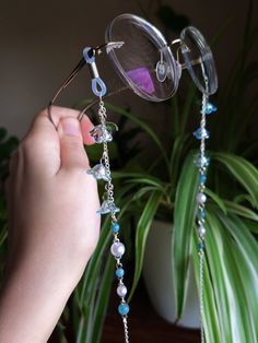 Introducing a glasses chain inspired by the enchanting bluebell flowers. This delicate piece features intricate flower beads, complemented by soothing aquamarine beads and imitation pearls. Designed to add a touch of femininity to your eyewear, this chain is as elegant as it is functional. Elevate your accessory game with this enchanting wisteria-inspired glasses chain. This eyeglass chain might be slightly heavier than regular chains because of some stone beads and crystals. Actual colors of an Cheap Glasses Chains With Colorful Round Beads, Glasses Accessories Jewelry, Chains For Glasses, Cute Glasses Chain, Blue Beaded Glass Glasses Chains, Blue Glass Jewelry For Festivals, Elegant Adjustable Blue Glasses Chains, Elegant Blue Adjustable Glasses Chains, Whimsical Silver Glass Jewelry