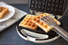 two waffles on a plate with a fork