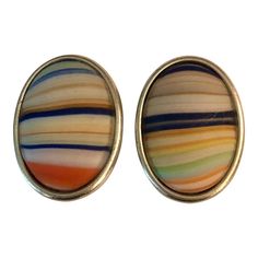 This is part of Chairish’s Costume Jewelry assortment.  This pair of vintage Ben-Amun Colorful Striped Agate Stone Oval Clip On Button Earrings area standout with their colorful striped design. So unique, these earrings will be a fantastic option with jeans during the day or dressed up for a night on the town. Fun, practical and simply stunning.      Dimensions: .8″W x 1.2″L x .25″H     Condition: Excellent vintage condition; please see pics for details.     Marks: Ben-Amun Luxury Clip-on Oval Cabochon Earrings, Ben Amun Earrings, Luxury Green Oval Cabochon Earrings, Chanel Stud Earrings, Vintage Multicolor Clip-on Earrings For Party, Retro Multicolor Clip-on Earrings, Vintage Multicolor Round Clip-on Earrings, Black Stud, Gemstone Stud Earrings