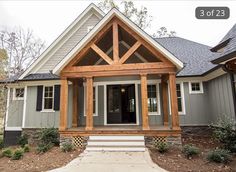 a house that has been built with wood and sidings on the front door, porch, and entryway