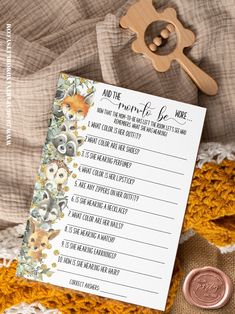 a notepad with the words and flowers on it next to a wooden spoon, money and