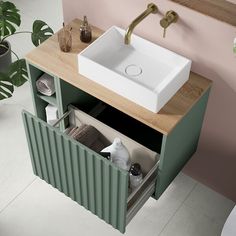 a white sink sitting on top of a wooden counter