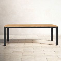 a wooden table sitting on top of a white tiled floor