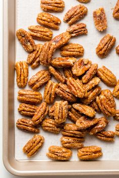 a tray filled with pecans on top of a table