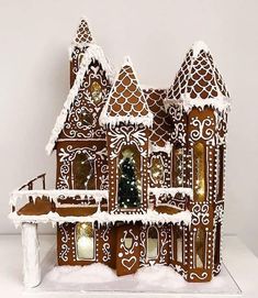 a gingerbread house is decorated with white icing