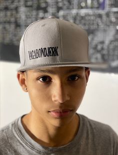 "**Just 1 left** Gray with black stitching  \"VagabondJerk\"  Snapback hat is an attention grabbing perfect way to show off your unique style & individualism. Embrace your stylish side with this Vagabond Jerk New York exclusive.  Vagabond Jerk New York is a combined effort of our two in-house artists, Noelle Winters and C.S. Hughes. Who started the thought process more than ten years ago, through roads, hills, mountains and time are now  bringing their art & the Vagabond Jerk New York fashion to people everywhere." Fitted Snapback Cap For Streetwear, Fitted Flat Brim Baseball Cap For Streetwear, Fitted Snapback Baseball Cap For Streetwear, Fitted Hats For Streetwear, Fitted Casual Baseball Cap For Streetwear, Casual Fitted Baseball Cap For Streetwear, Gray Urban Snapback Hat For Streetwear, Streetwear Fitted Baseball Cap, Fitted Baseball Cap For Streetwear