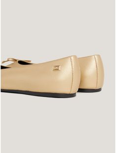 Tommy Hilfiger women's shoe. One of our favorites—the classic ballerina flat. Rendered in gold leather with our signature stripe strap, this classic performer takes you from the workday into the holidays with ease. Luxury Gold Ballet Flats, Chic Gold Leather Ballet Flats, Elegant Gold Leather Ballet Flats, Gold Leather Slip-on Ballet Flats, Gold Leather Ballet Flats For Formal Occasions, Classic Gold Flats With Flat Heel, Gold Ballet Flats For Formal Occasions, Gold Leather Ballet Flats With Round Toe, Gold Leather Ballet Flats With Flat Heel