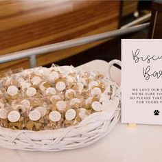 a basket full of cookies sitting on top of a table next to a sign that says biscuit bear