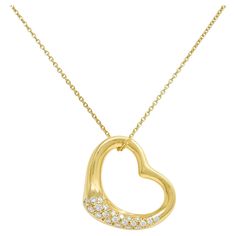 Comprised of a 1.5 mm cable link chain suspending a heart-shaped pendant With a sinuous organic design and pavé set with round brilliant cut diamonds Weighing approximately 0.55 carat total - G color with VS1 clarity Completed by spring clasp closure with logo tag Stamped for 18 karat gold Fully signed for Tiffany & Co. Elsa Peretti, Spain Circa: 2000s; form the Open Heart Collection Pendant measures: 15/16 x 1 1/16 inches Chain length: 18 inches Total length: 19 1/16 inches Total weight: 15.5 g Elsa Peretti Tiffany, Elsa Peretti, Logo Tag, Organic Design, Tiffany And Co, Open Heart, Heart Pendant Necklace, Round Brilliant Cut Diamond, Brilliant Cut Diamond