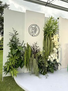 a woman standing in front of a display of flowers