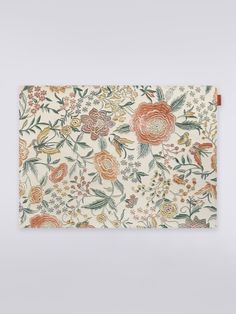 an orange and white floral print placemat on a gray surface with a wooden frame