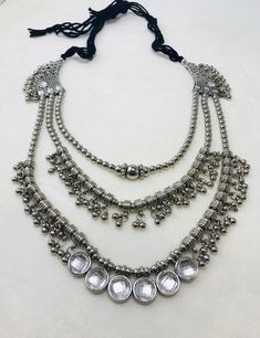 This beautiful necklace has a unique 3 layered design. Each layer has a beautiful design. It comes with an black tie thread to adjust the length of the necklace according to your wish.  This jewelry is perfect for dance performances or belly dancers. You can pair it up with any western or traditional outfit. It is perfect for Navratri Garba or any other festive occasion. -Please contact me if you have any other questions regarding this product. -Care Instructions Keep the jewelry set away from water and perfume. -Please check out the other listings on my shop. -Note: Due to the handmade nature of this item, minor inconsistencies in color and finish should be expected as it adds to the uniqueness of this item. Navratri Jewellery Silver, Luxury Ceremonial Necklace For Navratri, Adjustable Metal Layered Necklace For Parties, Bohemian Adjustable Layered Choker Necklace, Adjustable Bohemian Layered Choker Necklace, Silver Adjustable Layered Necklace For Party, Bollywood Style Necklace For Navratri Party, Bohemian Silver Layered Choker Necklace, Silver Bohemian Layered Choker Necklace