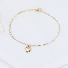 "14k Gold Heart Bracelet - Dainty 14K Gold Bracelet ★ The chain is 14k solid gold ★ The components are 14K yellow gold ★ The small heart charm is about 11 mm x 6mm, it is hollow 14k gold. The length includes the chain and the closure. ** How to choose a correct size of bracelet. 1. Measure your wrist below the wrist bone using a flexible tape measures, a string or a strip of paper. 2. If using a string or a strip of paper, mark length. Then, measure it with a ruler. 3. To find the bracelet size, Classic Everyday Heart Charm Bracelet, 14k Gold Bracelet With Heart Charm For Everyday, Yellow Gold Heart Bracelet For Everyday, Classic Everyday Bracelets With Heart Charm, Everyday Yellow Gold Heart Bracelet, Dainty Gold Bracelet With Heart Charm For Everyday, Dainty Chain Bracelet With Charms For Everyday, Everyday 14k Gold Bracelet With Heart Charm, Elegant Everyday Heart Bracelet With Charms