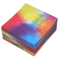 a stack of multicolored napkins sitting on top of each other in front of a white background