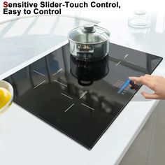 a person is pressing buttons on a glass top stovetop with the words, geniusive slide - touch control, easy to control