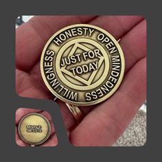 a person holding a medal in their hand with the words honesty open just for today on it